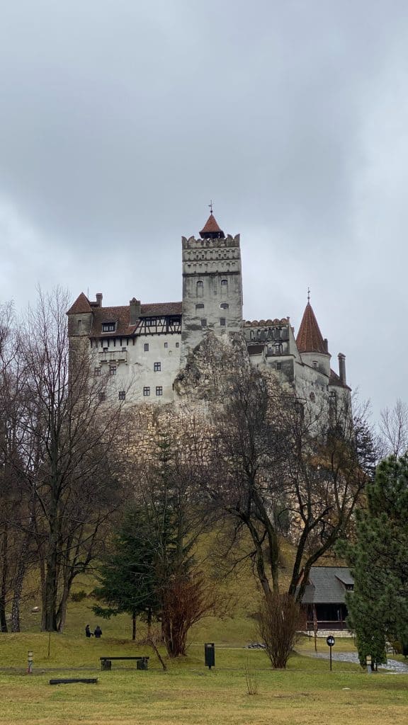 Dracula’s castle in Romania sitting up top of a hill.