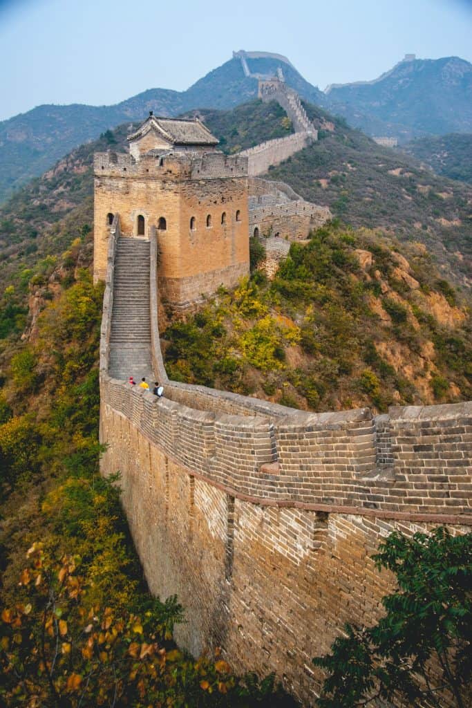 The great wall of china made of bricks along the wall leading up to a guard tower