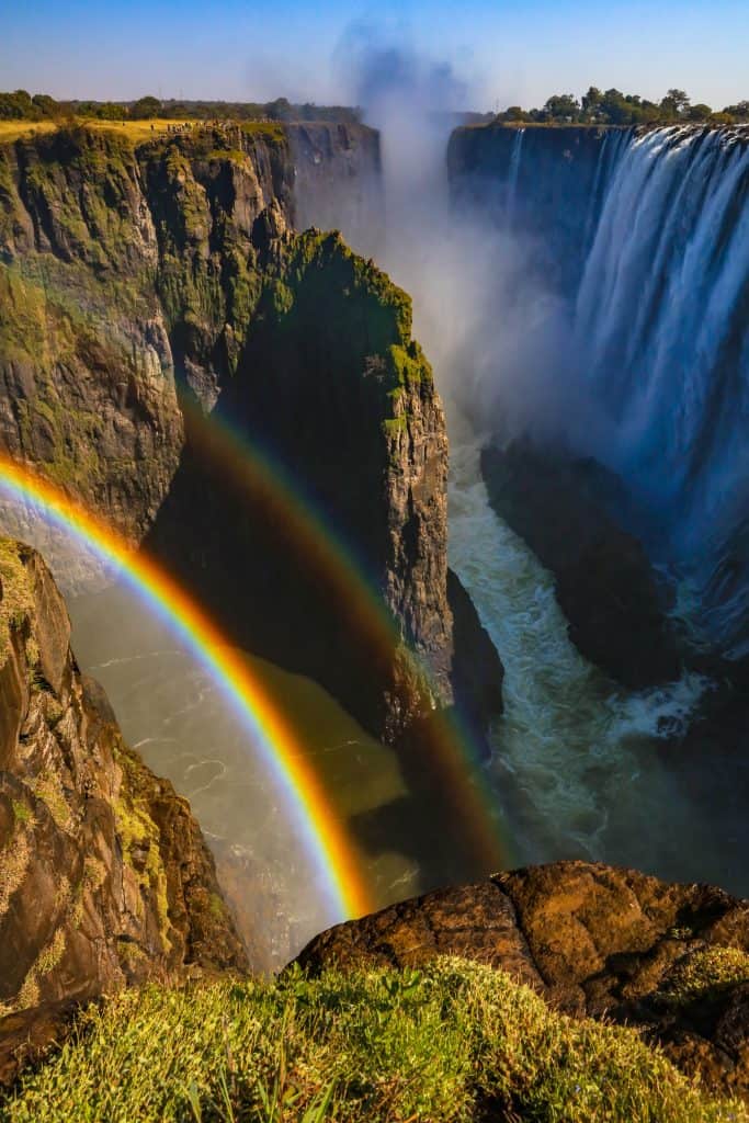 the waterfall, Victoria Fall in Zambia and Zimbabwe with mist and a rainbow.